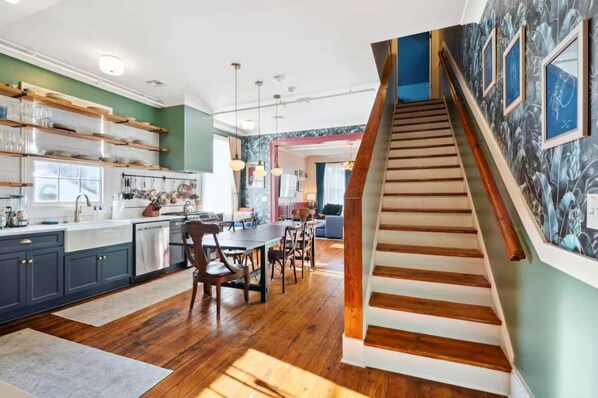 Staircase leading to bedroom 6 with king bed and full bathroom