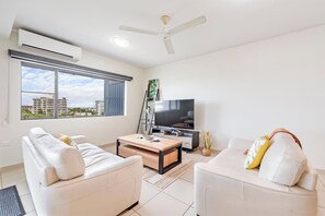 The living room is kept cool with split-system cooling and ceiling fans, ensuring year-round comfort.