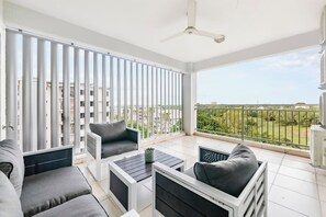 A balcony offers space for casual dining with the comfort of a ceiling fan and scenic views.