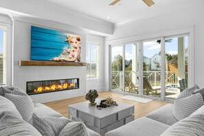 The Spacious Living Room Opens Up To The Pool Area