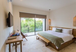 Spacious and comfortable room with a king-size bed and TV.