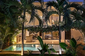 Spectacular patio with abundant natural vegetation and a pool.