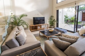 Comfortable and modern living room with a TV. Beautiful view of the garden.