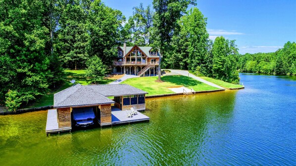 Stunning waterfront retreat with a private dock and serene wooded surroundings.