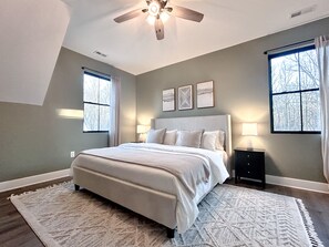 Primary bedroom with king bed and natural light. (1)