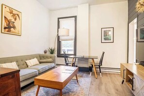 The apartment entrance welcomes you with soaring 10 ft ceilings, modern 10 light dimmable chandelier and ultra clean white and black green trimmed contrasting colors.  