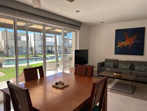 Open-concept living space with a dining area that seamlessly flows into the patio, perfect for indoor-outdoor living.