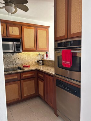 Fully stocked kitchen with modern appliances, including a dishwasher, offering everything you need for convenient meal prep and cleanup.