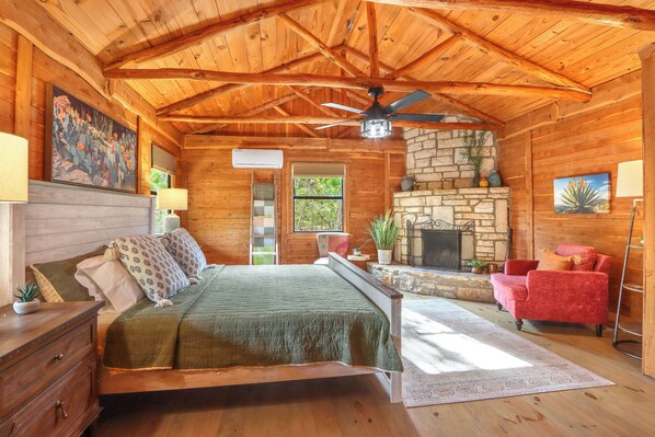 View of the bedroom at Sanderson with wood burning fireplace.