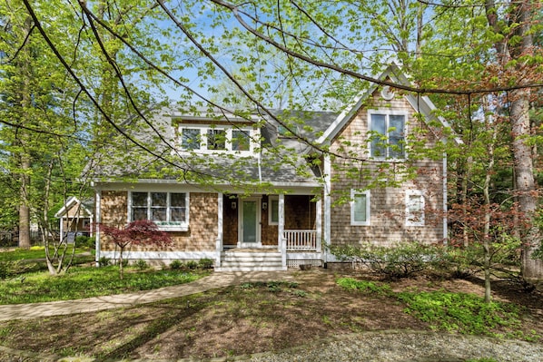 Tucked in the trees with porch vibes and storybook charm.