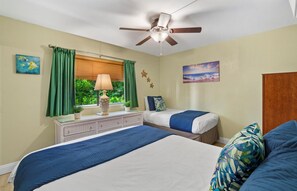 Guest bedroom features a twin and queen bed