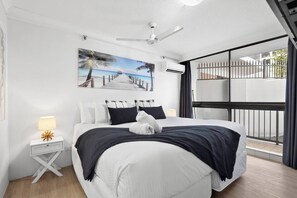 The primary bedroom offers a luxurious king-sized bed and access to a private ensuite for ultimate comfort.
