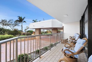 Step out onto the spacious balcony, where comfortable seating and views of the lush surroundings invite you to unwind.
