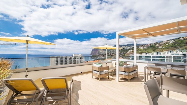 Experience luxury at SkyView Penthouse by LovelyStay, a 7th-floor retreat with a private terrace featuring a jacuzzi, gym, lounge area, and breathtaking views of the city, ocean, and mountains. #loungearea #outdoorfurniture #jacuzzi