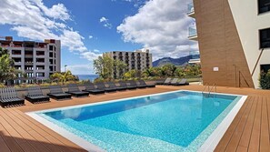 Enjoy a refreshing swim in the spacious, modern shared pool at SkyView Penthouse by LovelyStay, offering a relaxing space with stunning views of the surrounding city and landscape. #sharedpool