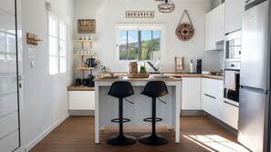 Experience culinary delight in the modern, fully equipped kitchen at Ozeanica Heights by LovelyStay, designed for style and convenience. #modern #fullyequipped.