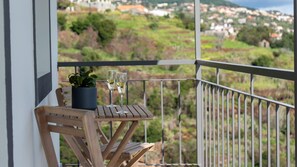 Unwind at the balcony’s outdoor table at Ozeanica Heights by LovelyStay, perfect for savoring wine or a delightful breakfast. #balcony #mountainview #cityview #oceanview