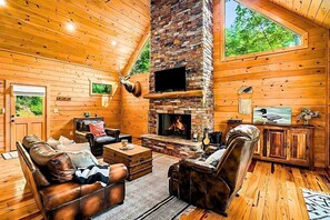 Experience the warmth and charm of log cabin living, with an inviting fireplace.