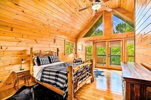 Pure cabin bliss! Wake up to peaceful views in this light-filled bedroom.
