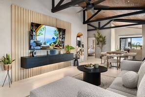 Relax in the open-concept living space with stylish modern design, perfect for gathering and unwinding after a beach day.