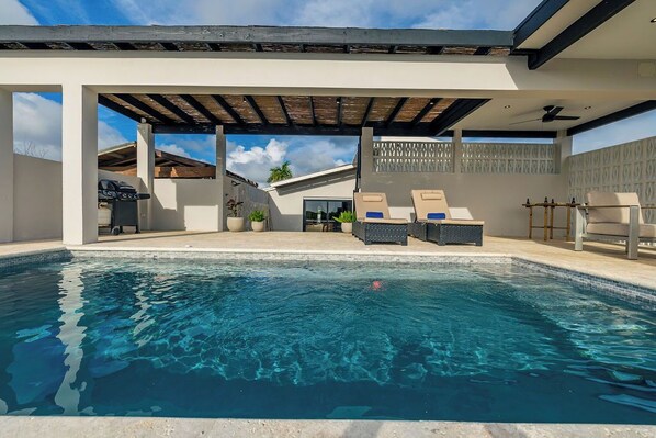 Soak up the sun or take a refreshing dip in the villa’s serene private outdoor space.