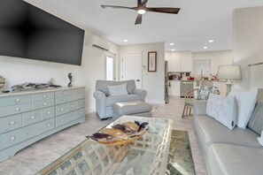 A large Smart TV with Comcast Cable and YouTube streaming is wall-mounted in the living area.