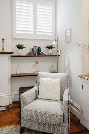 A cosy additional one-person sofa in the lounge, providing extra comfort and seating in the relaxed, inviting living space.