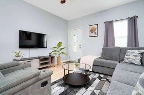 The perfect spot to kick back: a comfy couch and a 50" smart TV await you!