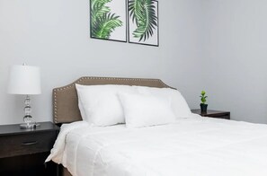 Experience comfort and tranquility in a bedroom featuring a plush queen bed.