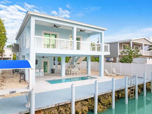 Escape to your dream getaway in this charming white house complete with a refreshing pool!