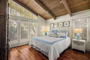 Primary bedroom with king bed and doors that open to the backyard