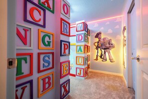 Bring the magic of childhood to life in this colorful room with Toy Story-themed bunk beds.