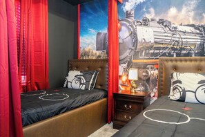 Step into a Hogwarts-inspired space with magical decor and cozy twin beds for wizardry dreams.