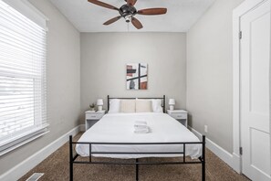 Relax and unwind in this first bedroom with a full bed, nightstands and lamps for your convenience. 