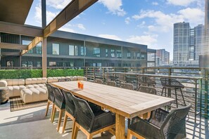Elevate your outdoor experience on the 6th floor balcony, featuring a spacious dining table for ten, cozy seating, and a serene spot to soak in the views.