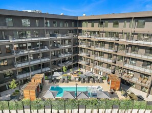 Communal Area: Sparkling blue pool with covered cabanas, sun loungers, and a wheelchair lift.