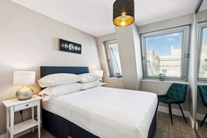 Bright double bedroom with stylish decor, soft linens, and large windows for plenty of natural light. Your cozy retreat in central Brighton.