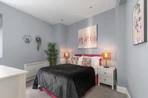 Chic King room with soft tones and warm lighting