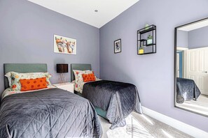 Twin room with modern style and vibrant accents