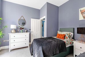 Cozy single room with modern decor and bold accents