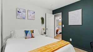 Relax and recharge in this cozy bedroom, featuring a comfortable queen size bed. 