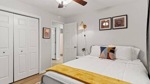Relax and recharge in this cozy bedroom, featuring a comfortable queen size bed. 