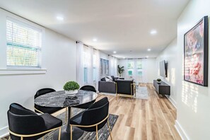 St Petersburg vacation rental open-concept living room with marble dining and modern art