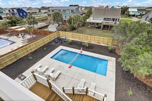 Private backyard with 14x35 heated pool, plenty of lounging, and fire-pit.