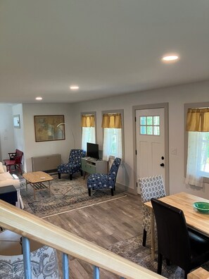 Living room, dining table, door to covered porch