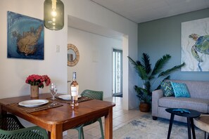 Cozy dining area at Diver’s Paradise Bonaire – enjoy meals with a view of the Caribbean Sea