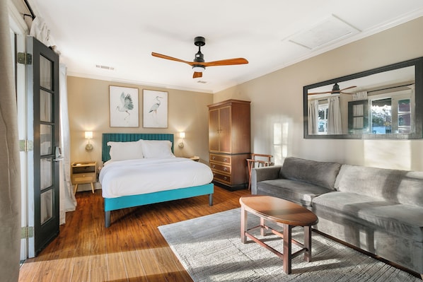 Bedroom #1 offers a queen-size bed, a queen sleeper sofa, and direct access to a garden. It shares a Jack-and-Jill-style bathroom with the adjacent bedroom.