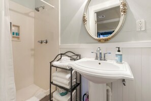 Bathroom with a walk-in shower and Nexxus toiletries.