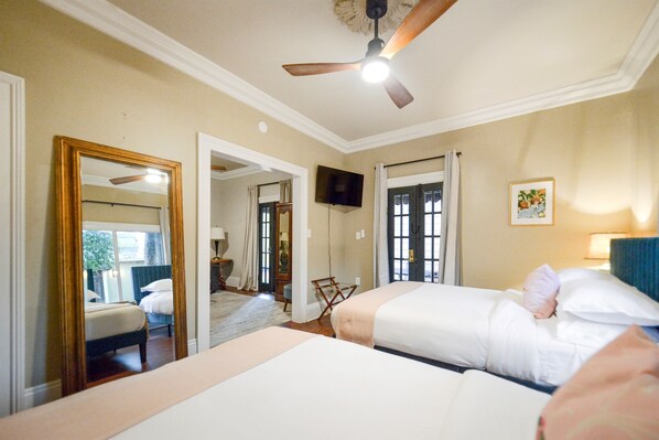 Spacious bedroom with two queen beds, top-rated linens, and inviting ambiance.