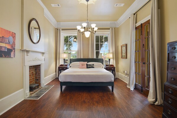 Grand king bedroom with 11-foot ceilings, a chandelier, and a private porch